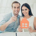Portrait of happy young family buying new house